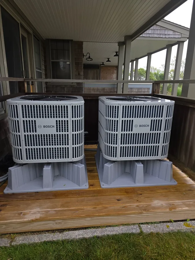 Two Bosch central air condensers installed on a raised deck platform