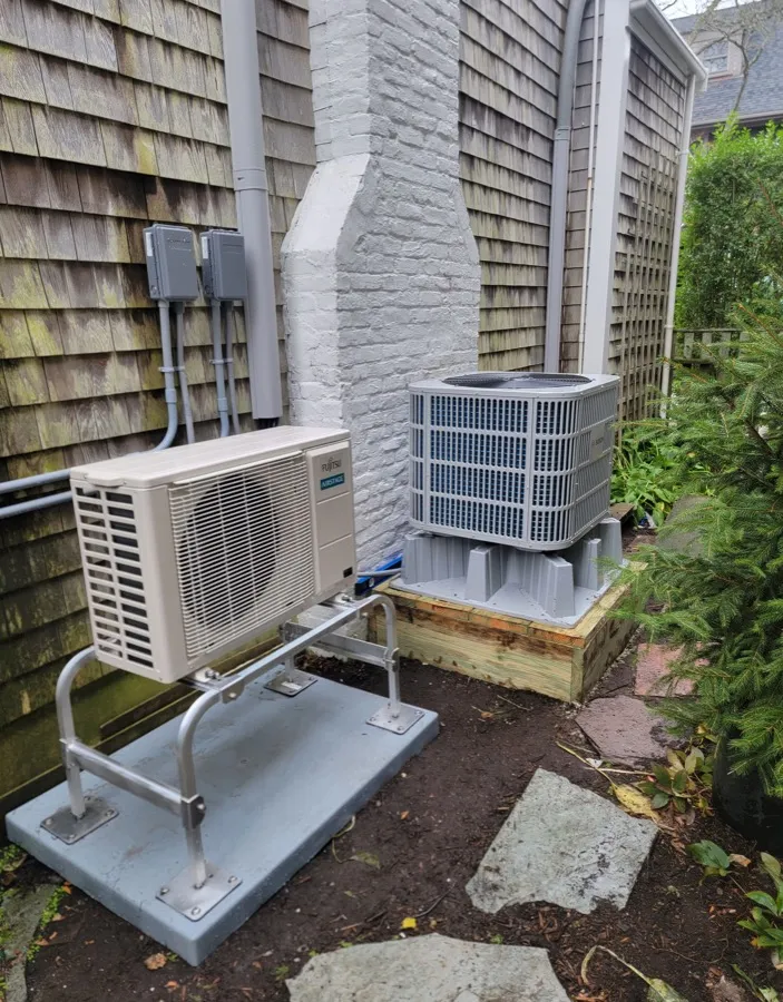 Fujitsu ductless unit and Bosch condenser installed against a shingled Cape Cod home