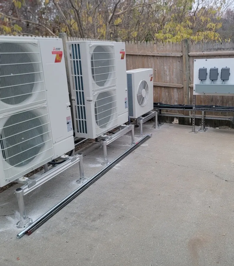 Row of Mitsubishi Electric multi-zone condenser units installed on an elevated equipment pad